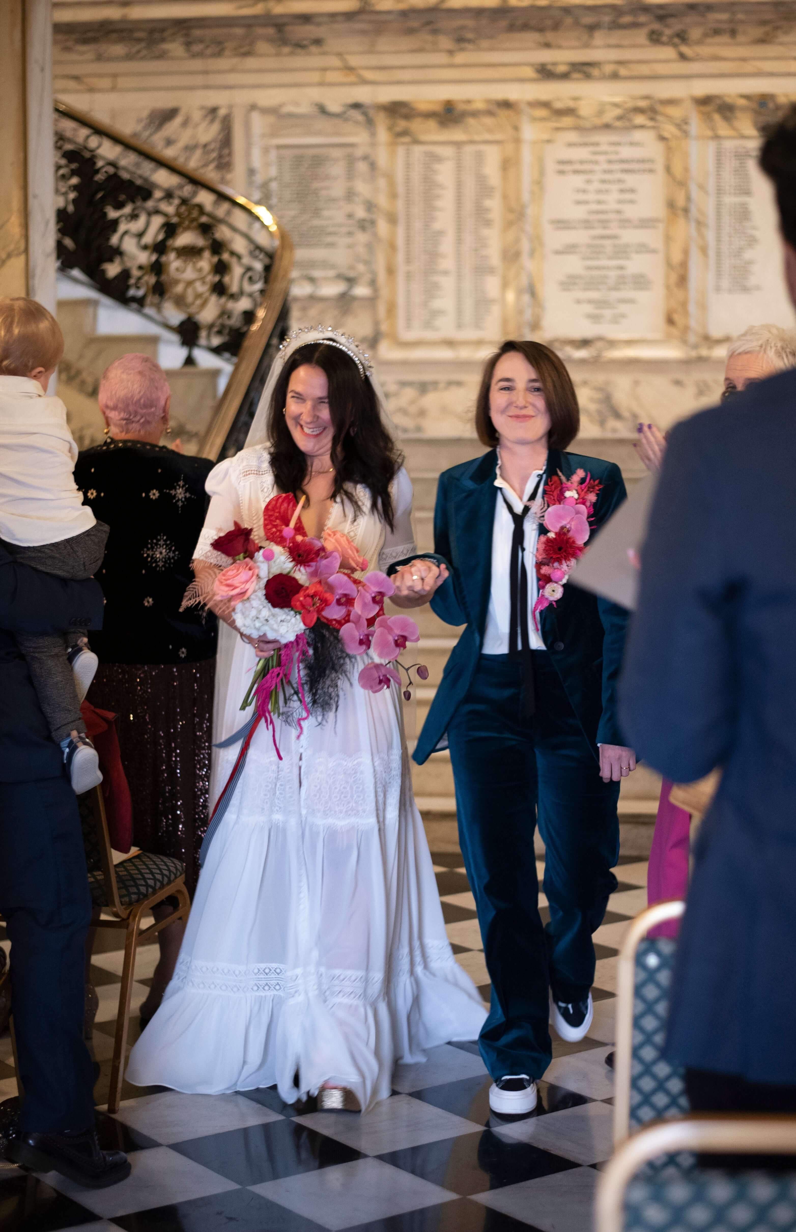 brides at wedding in Stockport Town Hall, red, pink and white modern wedding bouquet and a lapel arrangement