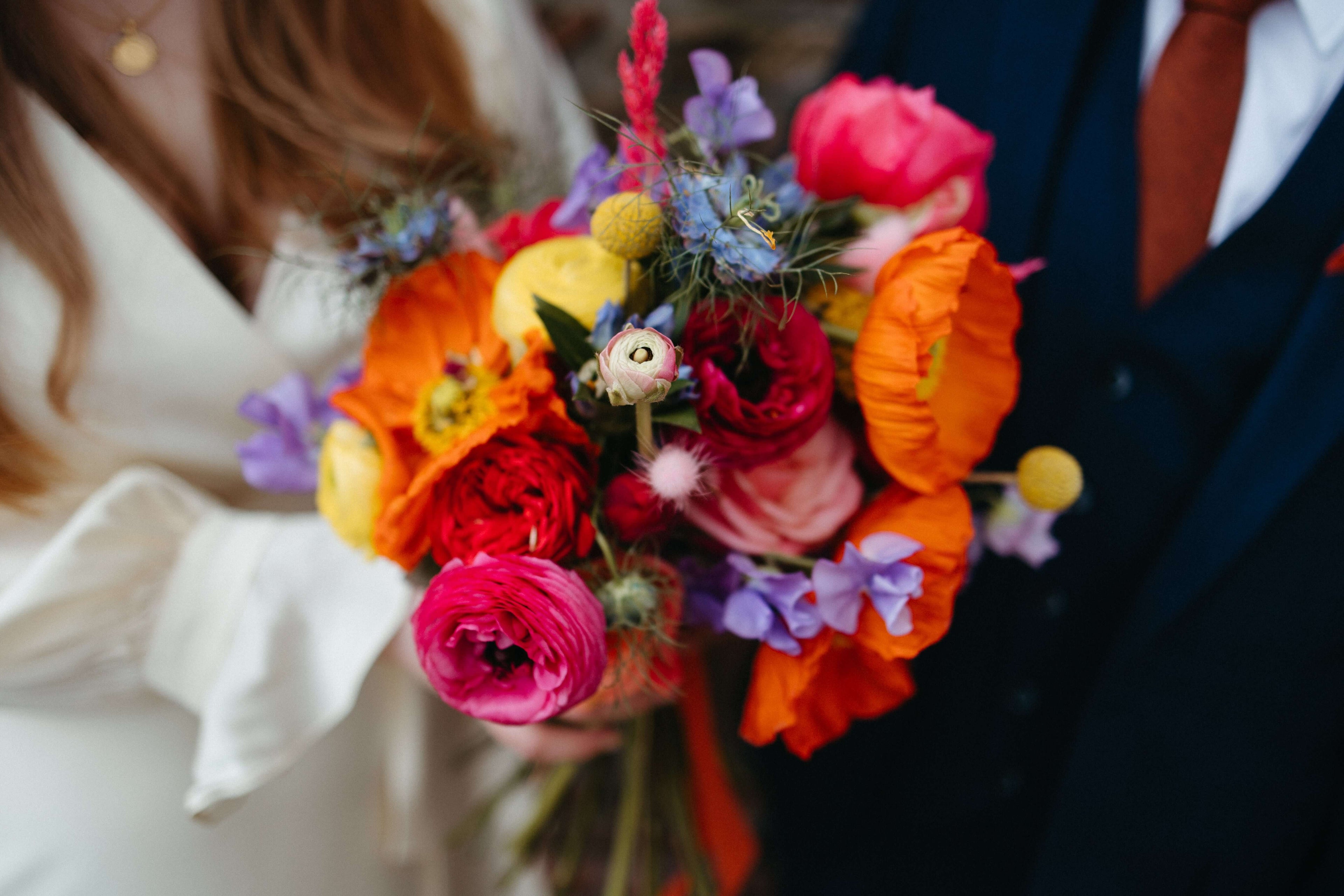 bright, colourful, vibrant bridal bouquet, close up photo with multi coloured wild flowers